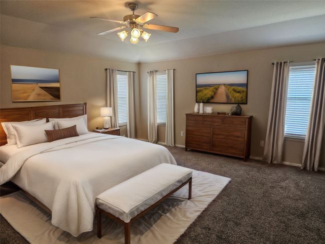 Bedroom featuring multiple windows, carpet, and ceiling fan | Image 17