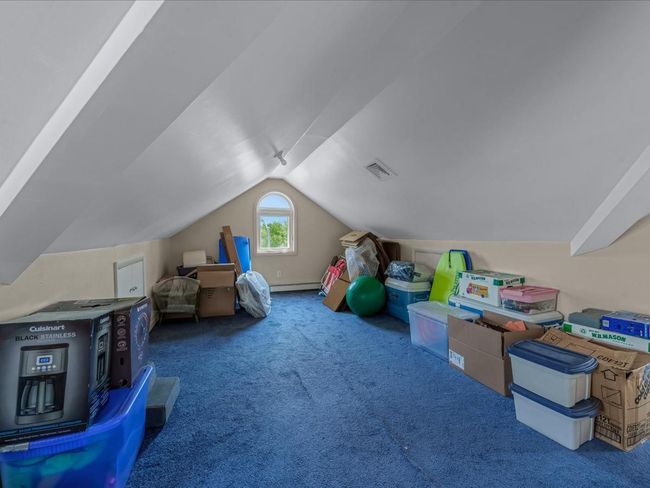 Rec room with carpet flooring, lofted ceiling, and baseboard heating | Image 26
