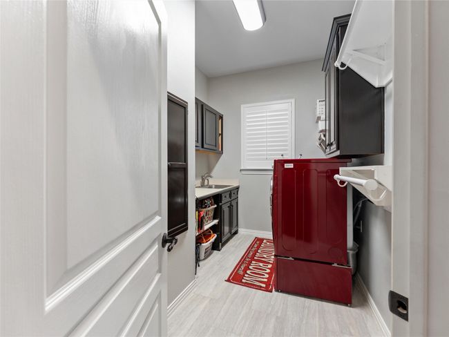 Washroom with cabinet space, light wood-style floors, and independent washer and dryer | Image 24