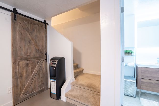 Stairs featuring a barn door and baseboards | Image 32