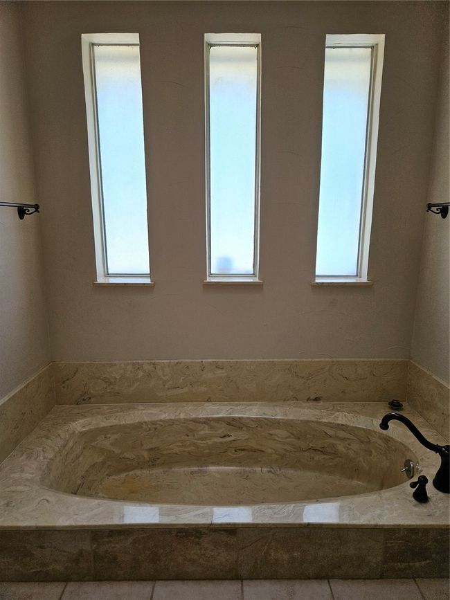 Full bathroom featuring a bath and plenty of natural light | Image 13