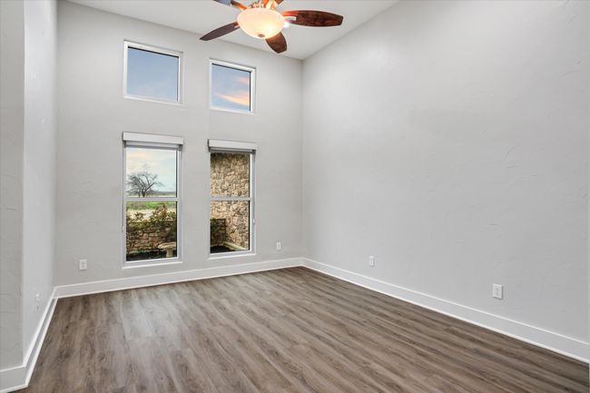 Unfurnished room with ceiling fan and wood-type flooring | Image 34