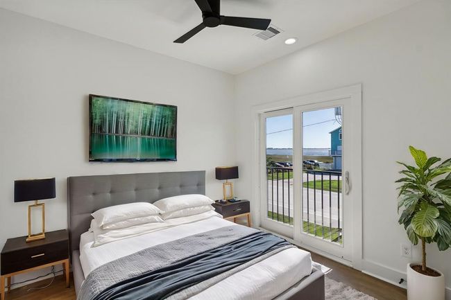 One of the two secondary bedrooms providing a comfortable and stylish space perfect for guests or family members | Image 21