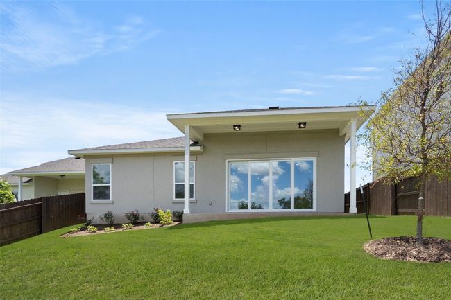 Rear view of house featuring stucco siding and roof with shingles | Image 35