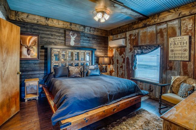Bedroom with hardwood / wood-style floors, a wall mounted AC, and wood walls | Image 6