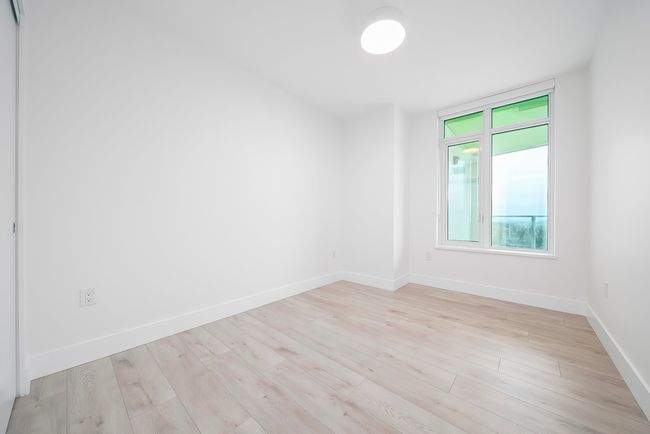 Spare room featuring baseboards and light wood-type flooring | Image 11