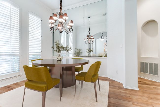 Dining room with a chandelier, crown molding, light wood-style flooring, healthy amount of natural light, and baseboards | Image 6