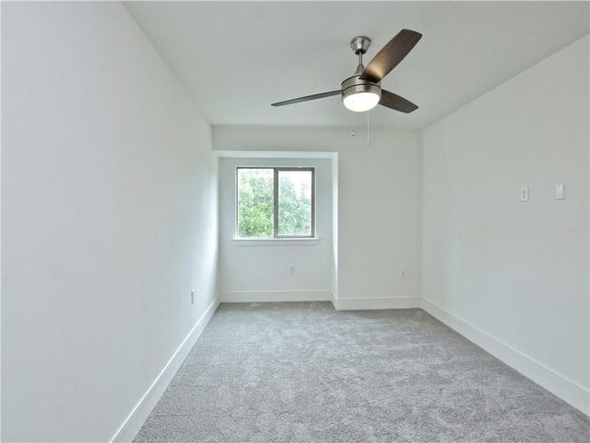 Carpeted empty room with a ceiling fan and baseboards | Image 21