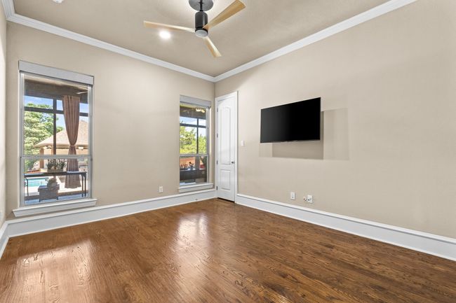 Unfurnished room featuring ornamental molding, a ceiling fan, and wood finished floors | Image 28