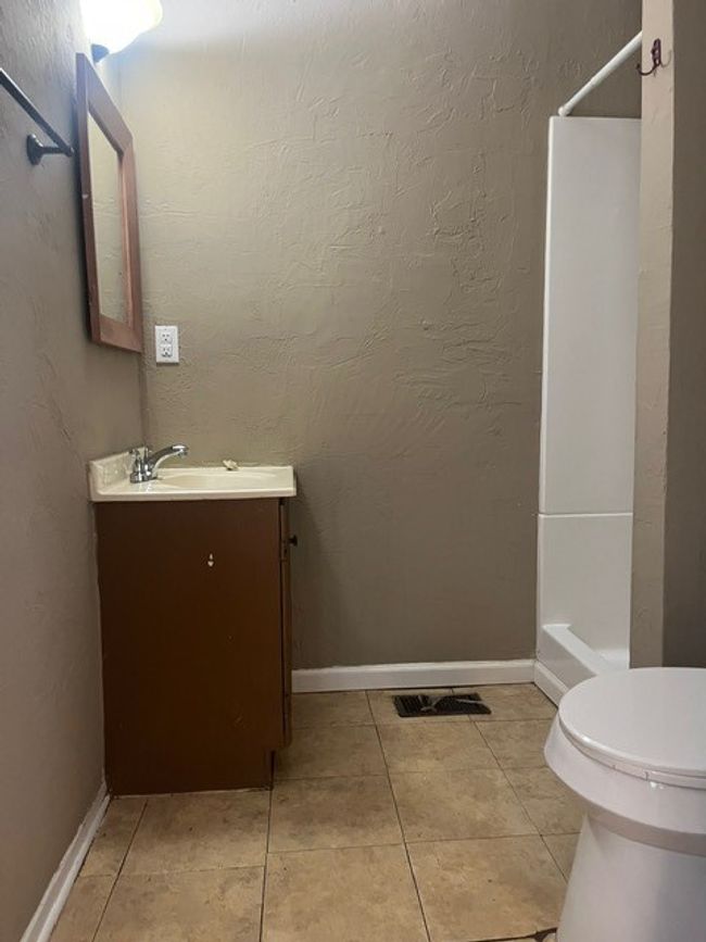 Bathroom with vanity, a shower, and tile patterned floors | Image 14