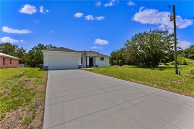 View of front of property featuring a garage and a front lawn | Image 2