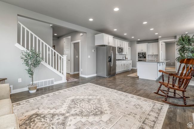 Kitchen with recessed lighting, visible vents, dark wood-style floors, and stainless steel appliances | Image 12