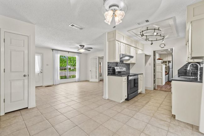 With its open layout, the kitchen flows into the den so you can stay connected with family or guests while cooking. | Image 10