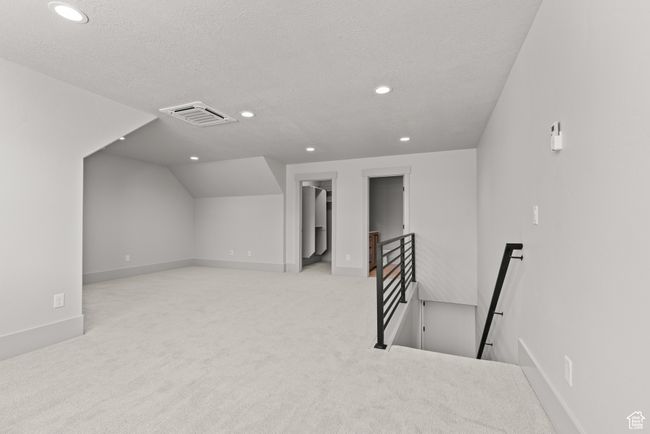 Additional living space with recessed lighting, carpet, a textured ceiling, and lofted ceiling | Image 26