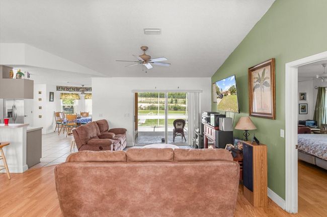 Living Room w/ Vaulted Ceiling, Laminate Flooring & Slider to the Covered, Screened Lanai | Image 12