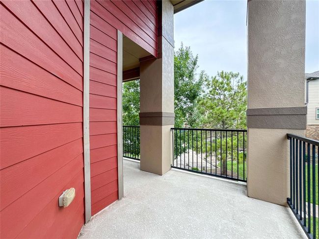 This townhome is an end unit that features a cozy balcony with access to the primary bedroom. It's an inviting outdoor space for relaxation. | Image 23
