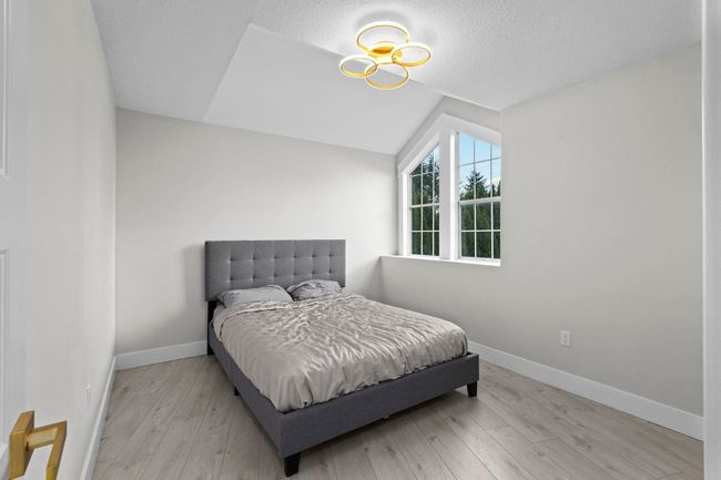 Bedroom with baseboards, vaulted ceiling, and wood finished floors | Image 29
