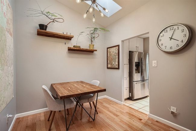 Dining area featuring a skylight and light wood finished floors | Image 5