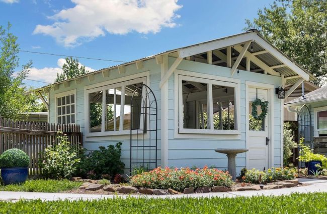 Alt view of the garden shed, showing details like the reclaimed windows and door. | Image 28