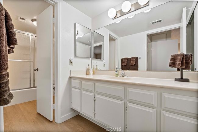 Large bright full bathroom has it's own private laundry. | Image 12