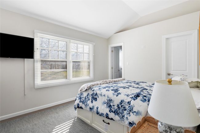 Bedroom featuring lofted ceiling and baseboards | Image 42
