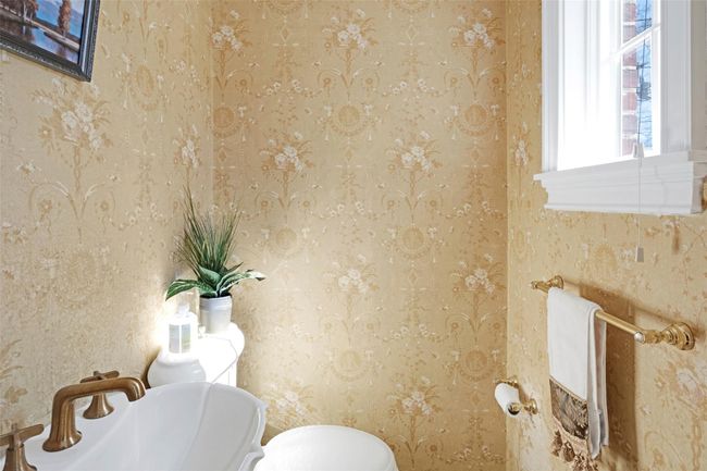 Bathroom with a sink, toilet, and wallpapered walls | Image 6