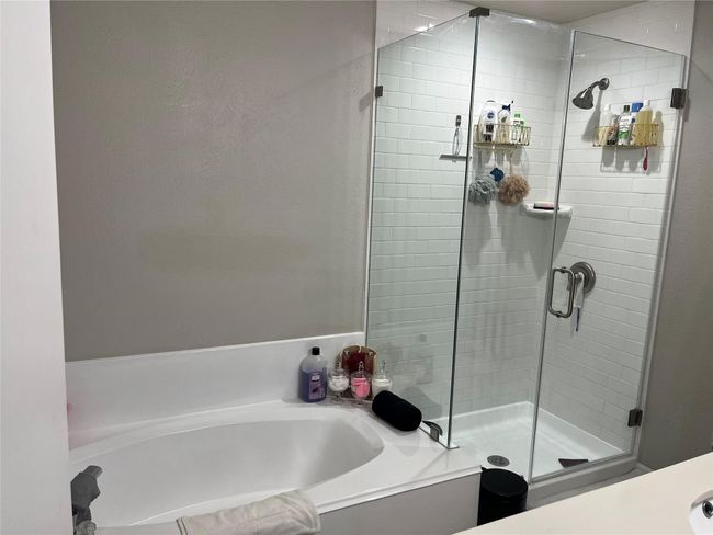 Bathroom featuring separate shower and tub | Image 6