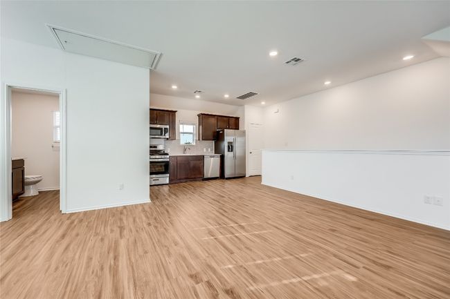 Garage apartment living room featuring attic access, light wood finished floors, and recessed lighting | Image 33