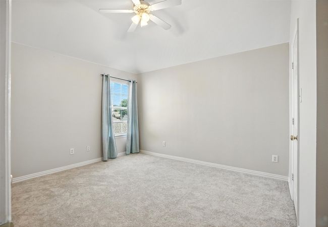 Empty room with light carpet, vaulted ceiling, and ceiling fan | Image 30