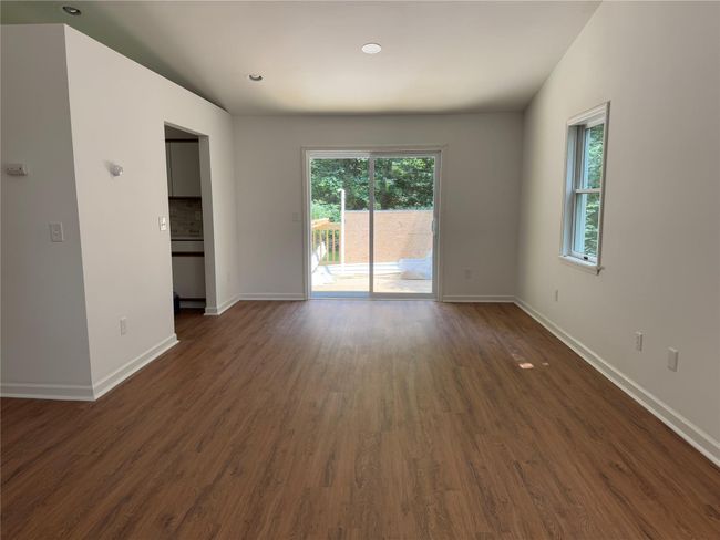 Empty room featuring plenty of natural light, dark wood-style floors, and recessed lighting | Image 4