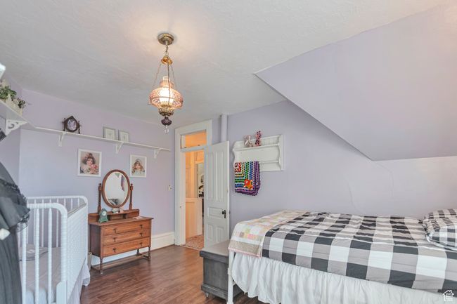 Bedroom featuring dark hardwood / wood-style floors and vaulted ceiling | Image 28