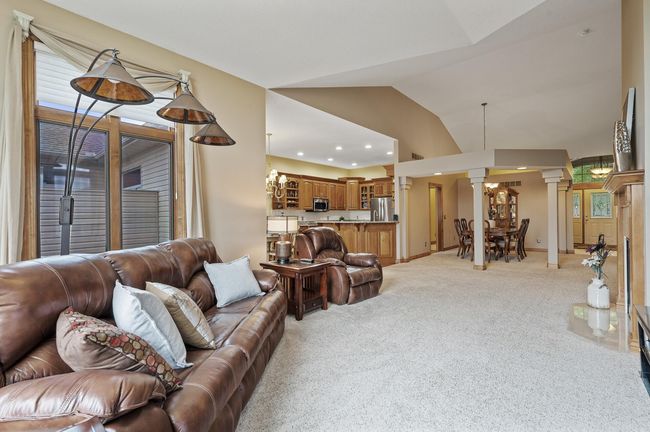 An open and spacious feel throughout the main level is filled by natural sunlight. This home provides multiple living spaces which includes the sought after feature of all living facilities on the main level. | Image 7