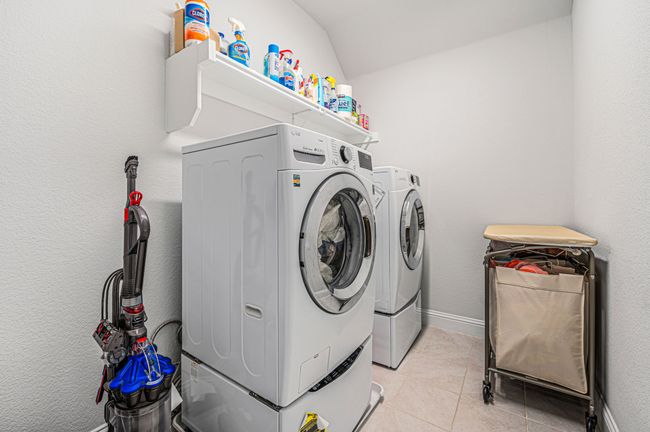 Conveniently located upstairs, the utility room offers ease of use and added functionality. | Image 31