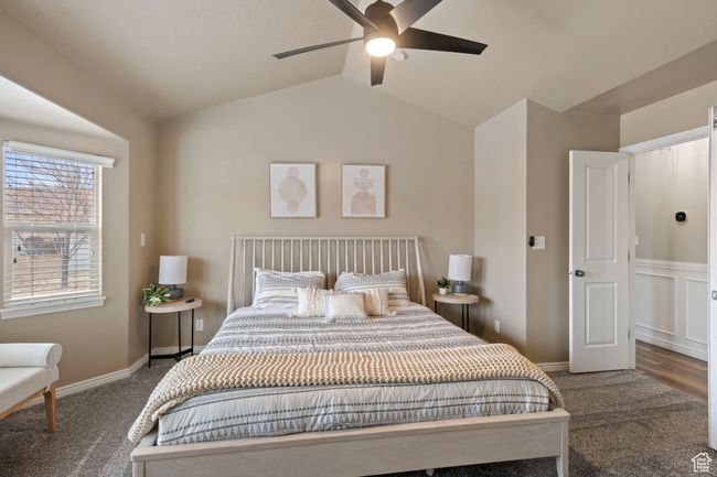 Bedroom with lofted ceiling, ceiling fan, and carpet flooring | Image 11