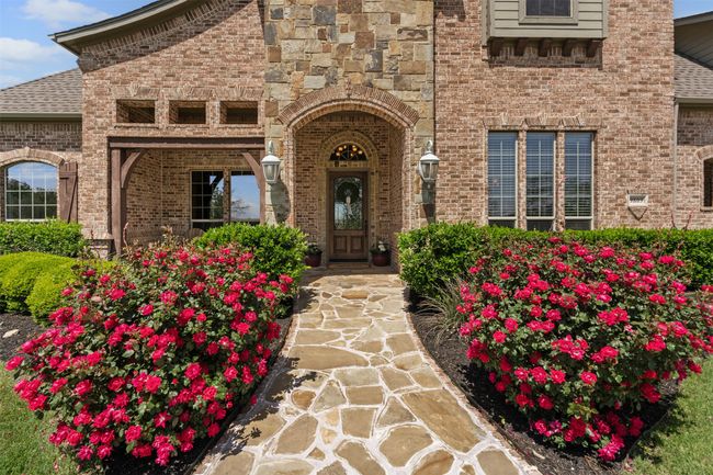 Entrance to property with roof with shingles and brick siding | Image 9