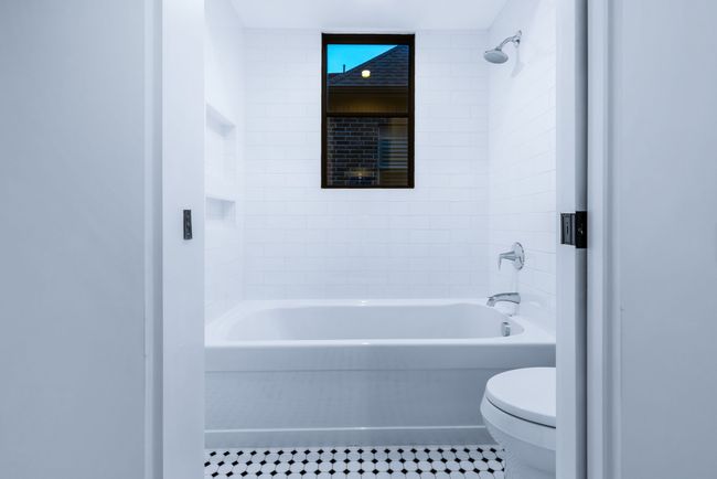 Bathroom featuring washtub / shower combination and tile patterned floors | Image 27