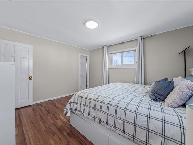 Bedroom featuring baseboards and wood finished floors | Image 16