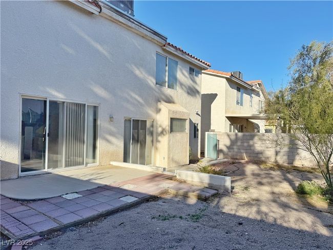 Back of property with a patio area, a tiled roof, fence, and stucco siding | Image 50