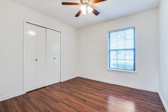 Unfurnished bedroom featuring wood finished floors, a closet, and a ceiling fan | Image 20