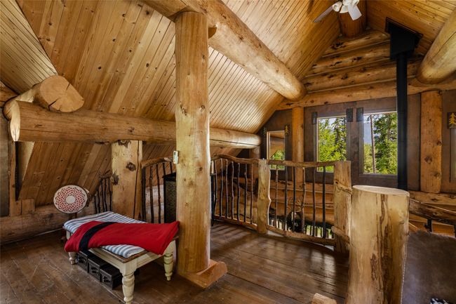 Bedroom featuring wood ceiling, wood-type flooring, and rustic walls | Image 26