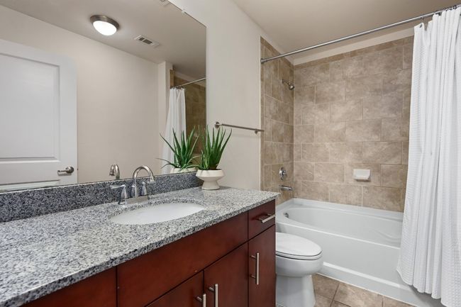 Full bathroom with vanity, shower / bath combo with shower curtain, tile patterned flooring, and toilet | Image 14