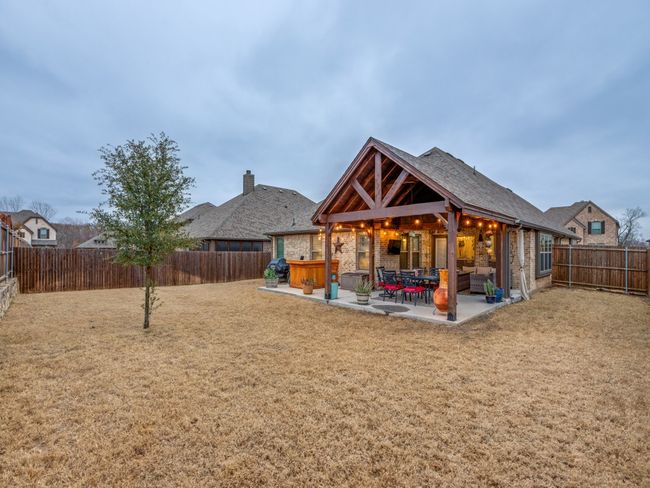 Rear view of house featuring a patio, a lawn, and a jacuzzi | Image 19