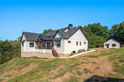 The home and garage w/ the huge yard! | Image 3