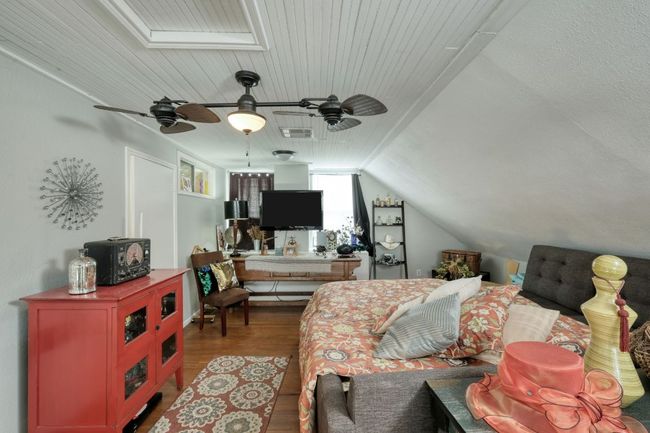 Bedroom featuring wood floors and lofted ceiling | Image 23
