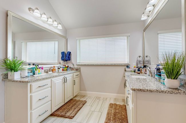 Bathroom with baseboards, vaulted ceiling, and vanity | Image 16