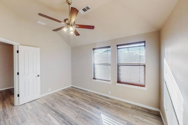 Empty room featuring vaulted ceiling, a ceiling fan, and light wood finished floors | Image 18