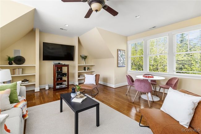 Site finished hard wood floors, surround sound, recessed lighting, ceiling fan with light, built in shelving. | Image 29