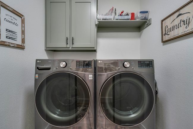 Laundry room with cabinets and independent washer and dryer | Image 15