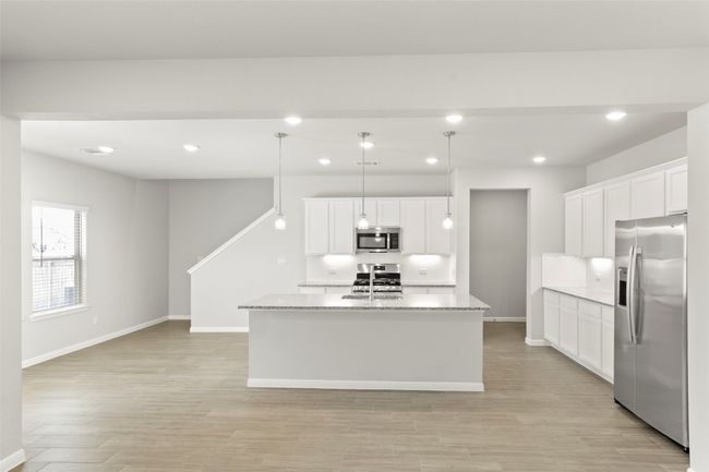 Kitchen with appliances with stainless steel finishes, decorative backsplash, light wood-style flooring, baseboards, and recessed lighting | Image 17