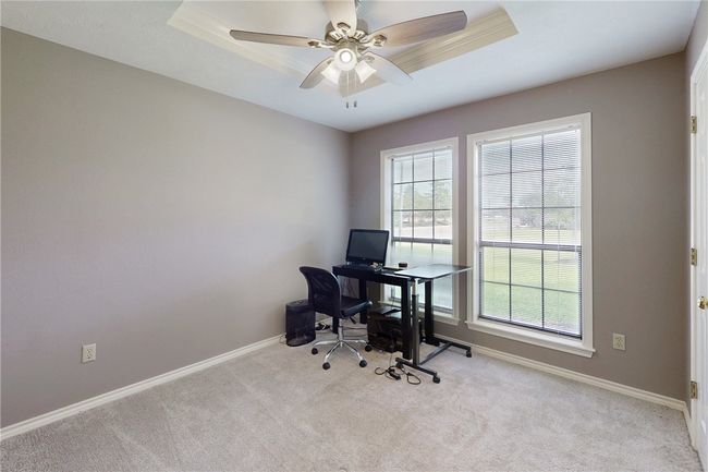 Office space featuring carpet floors, baseboards, and a ceiling fan | Image 18